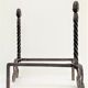 Pair of sculptural cast iron chenets with twisted heads