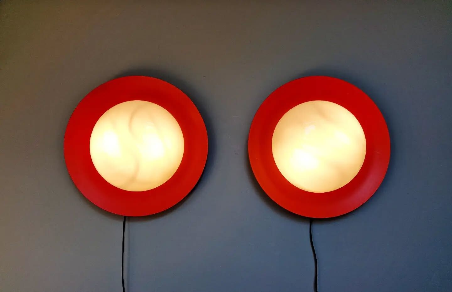 Pair of XXL Space Age wall sconces, orange lacquered metal and opaline, 1960.