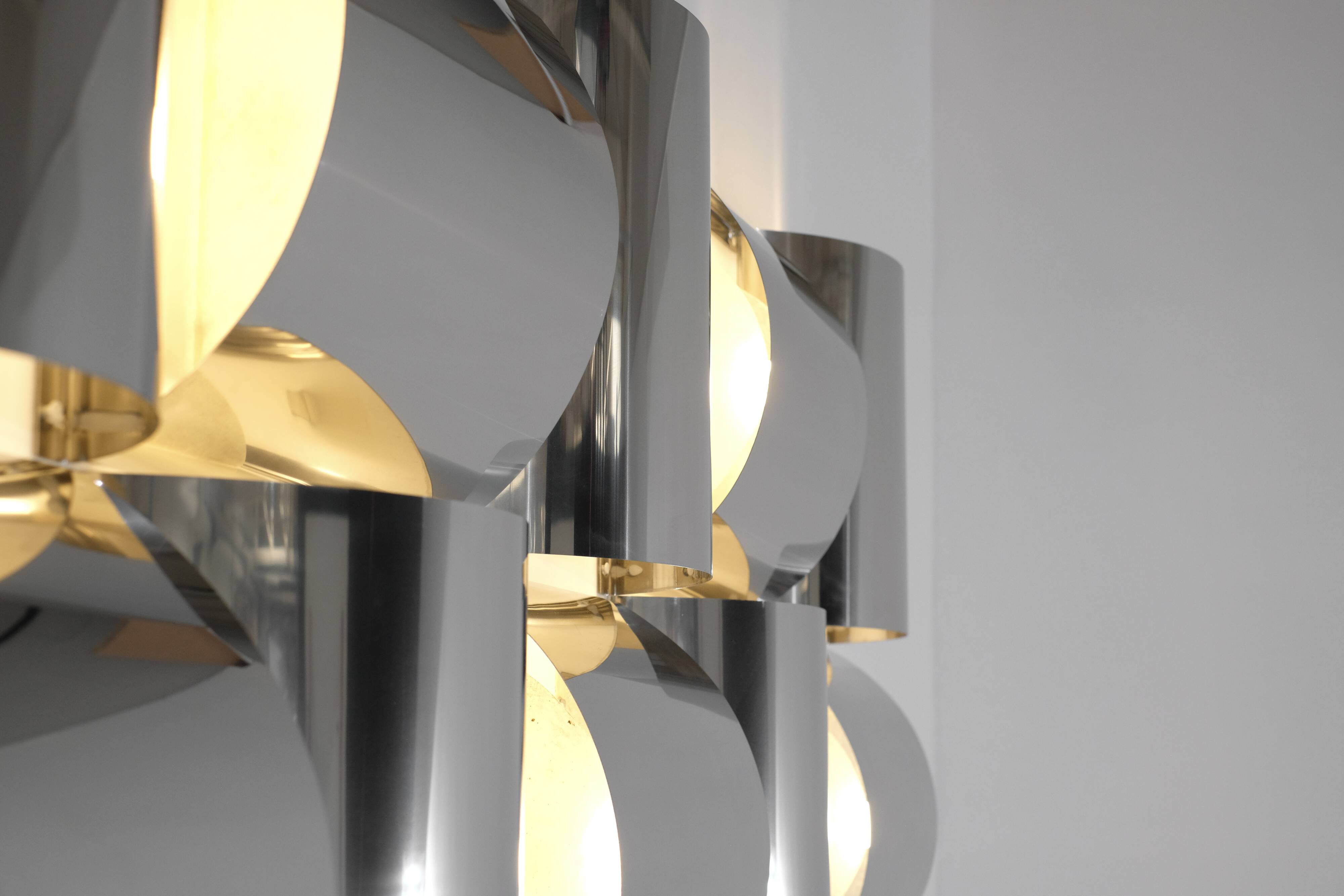 Contemporary wall light in stainless steel and metal.