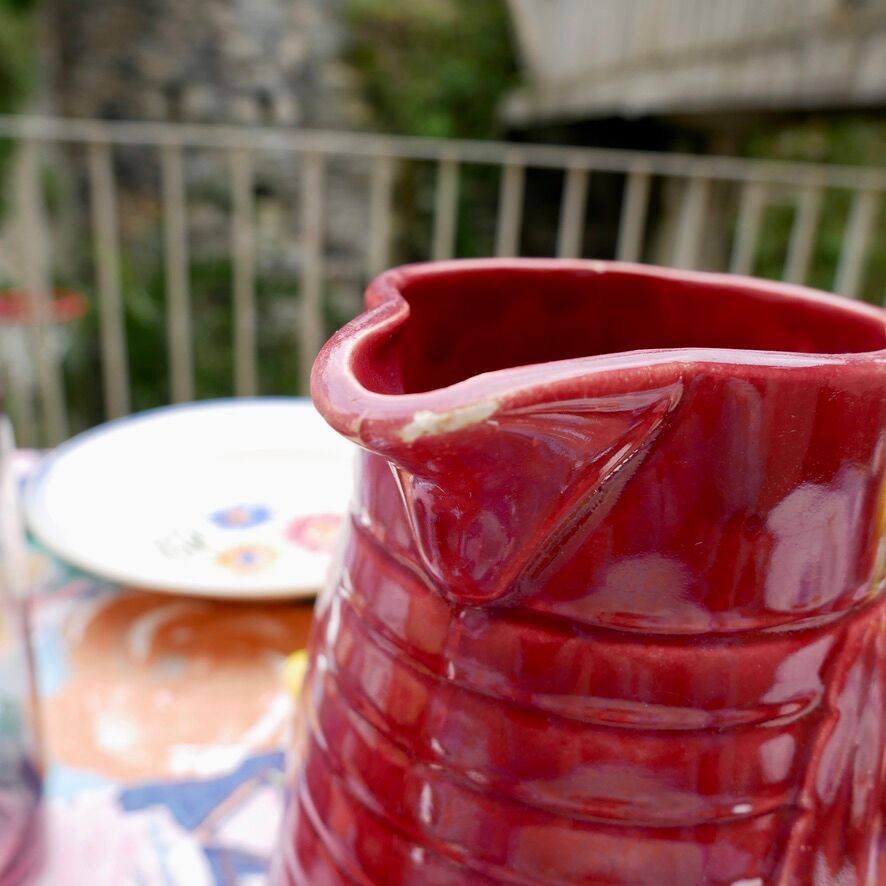 Burgundy/red ceramic pitcher