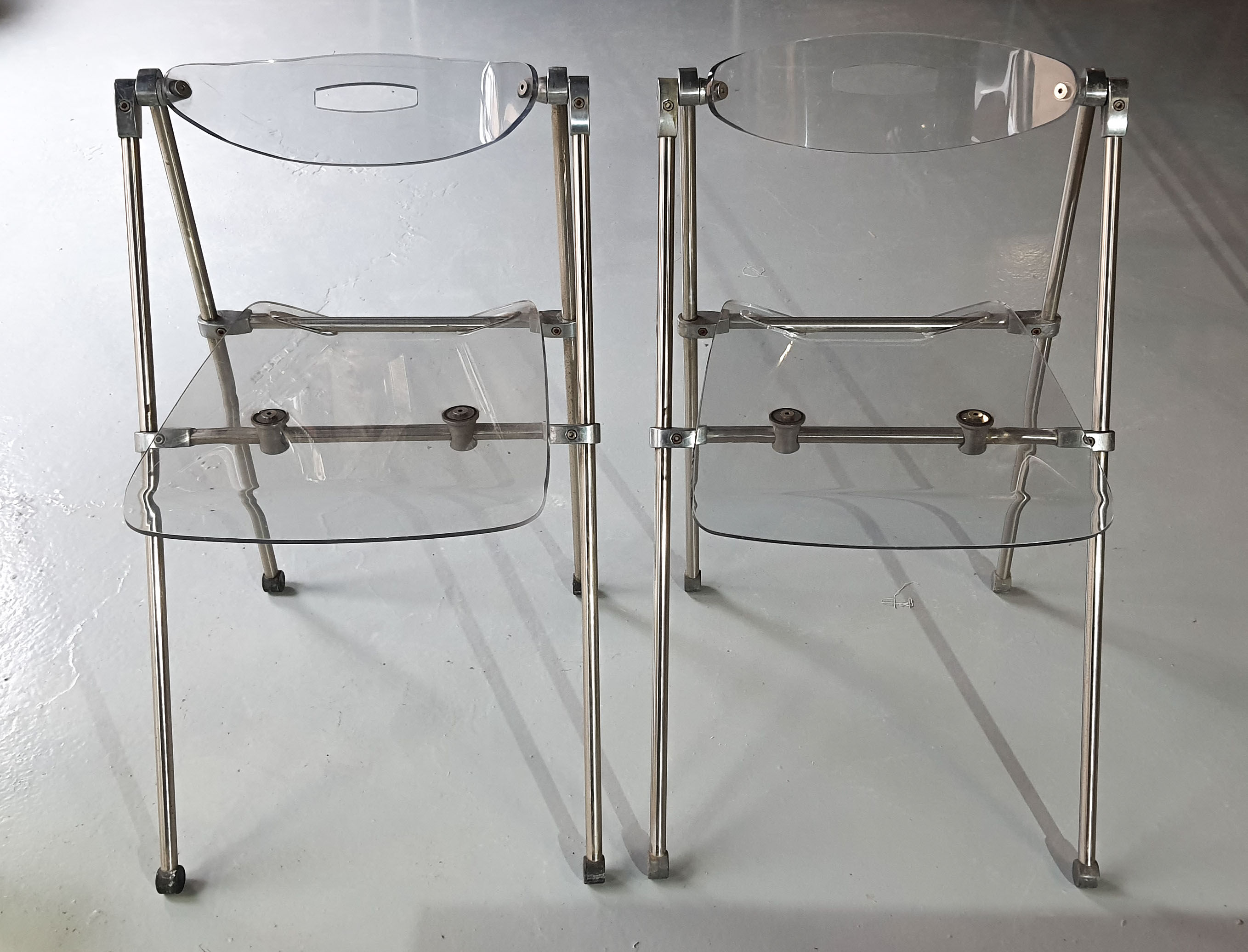 Pair of modern folding chairs in plexiglass