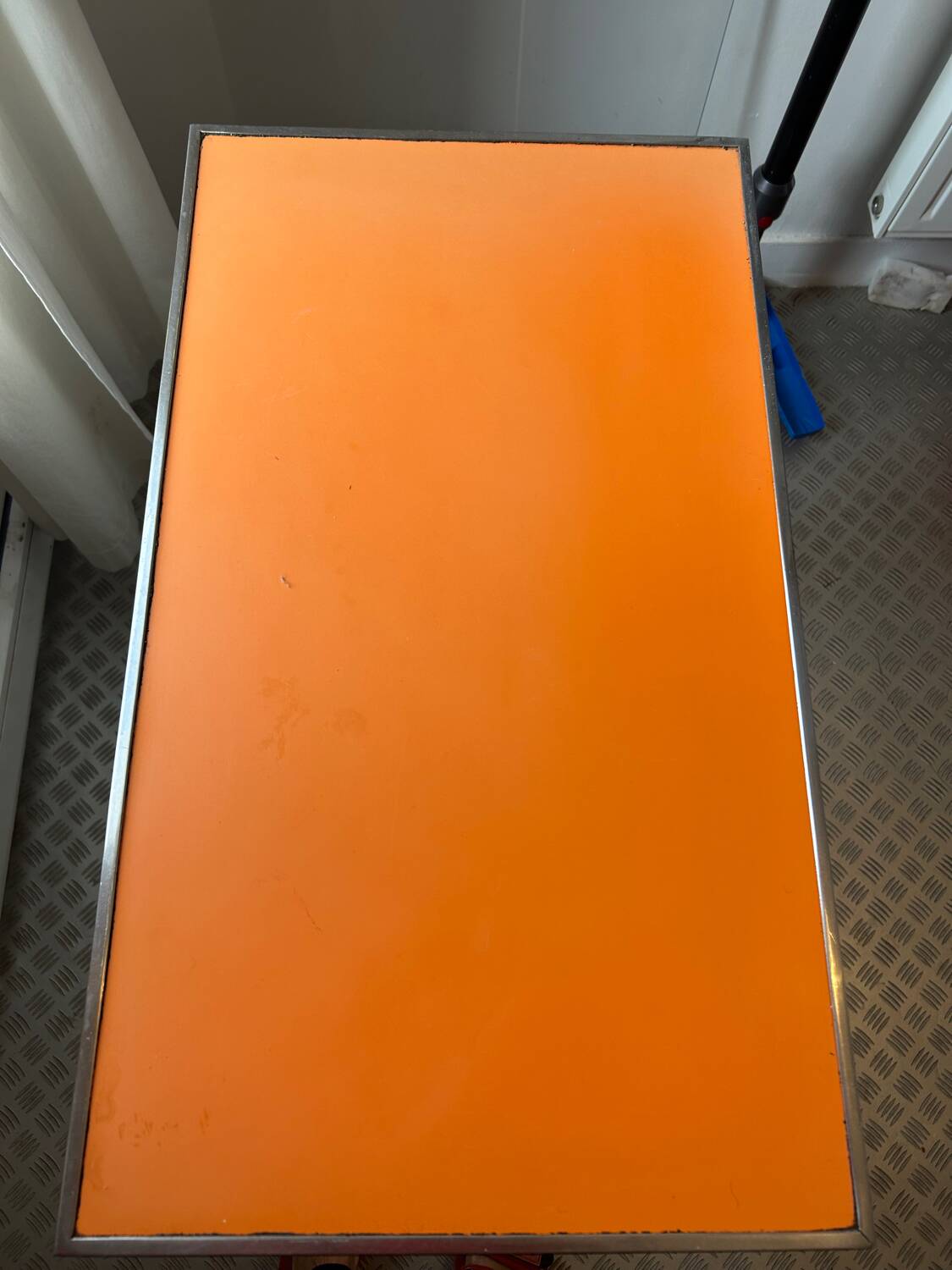 Orange wood and formica table