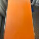 Orange wood and formica table