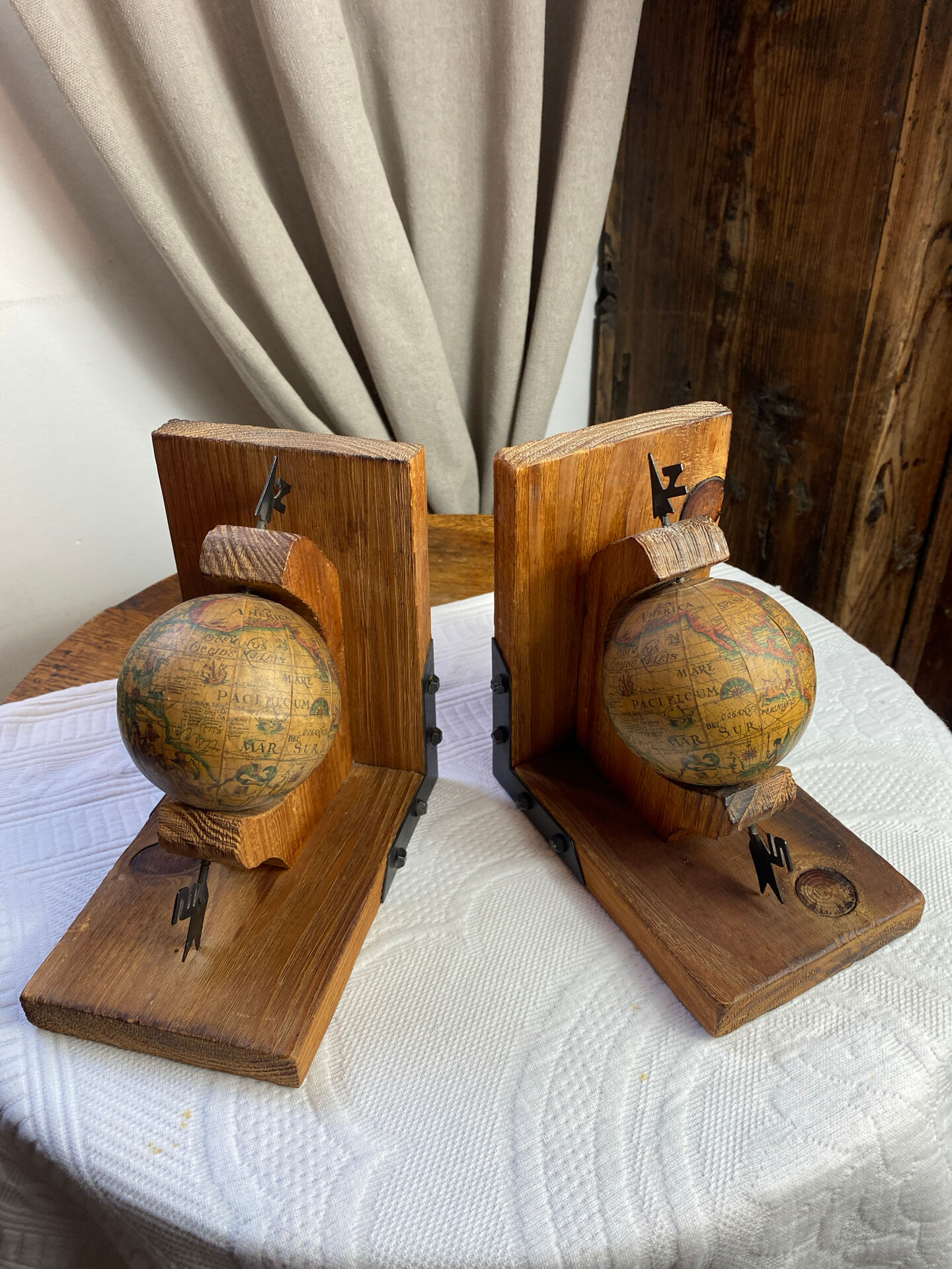 Pair of wooden bookends, rotating globes