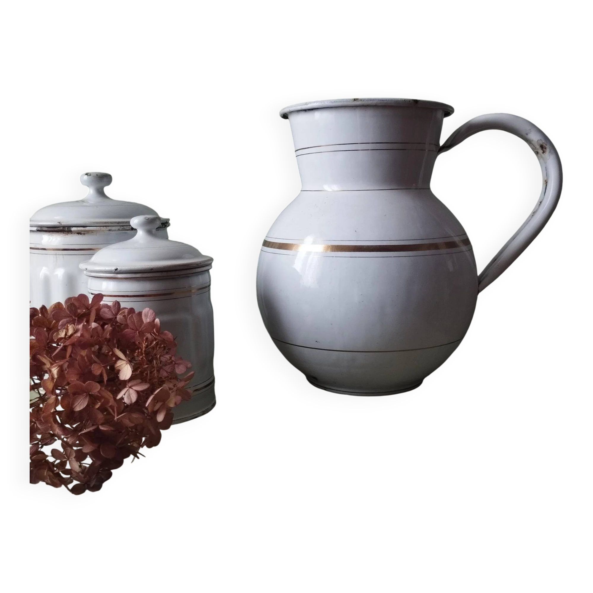 Old enamelled metal jug with gold trim.