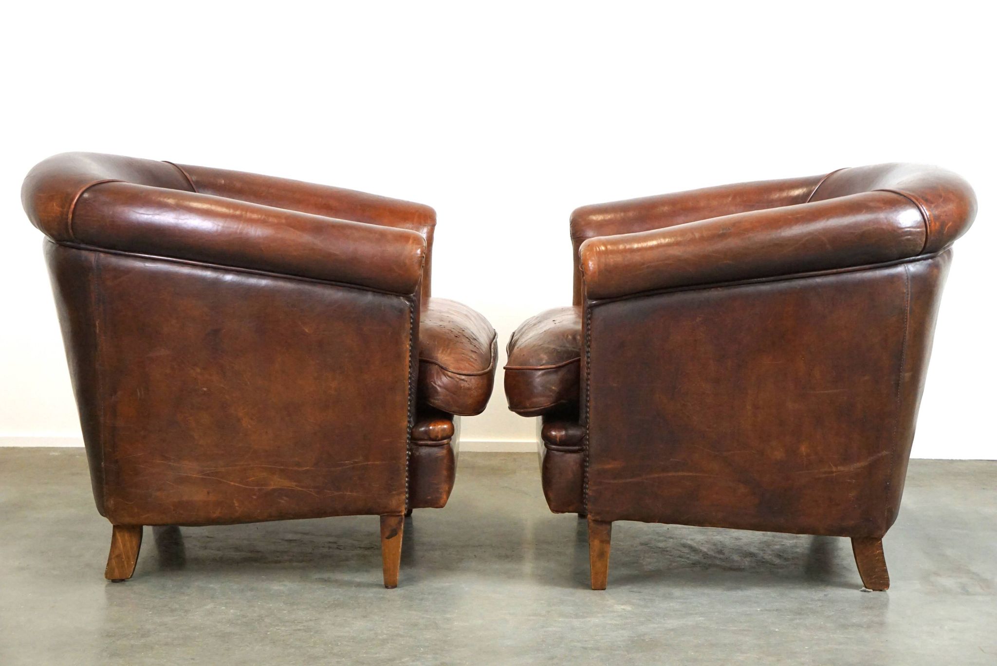 Set of two rugged sheep let of two rugged sheep leather club armchairs with a nice distressed look