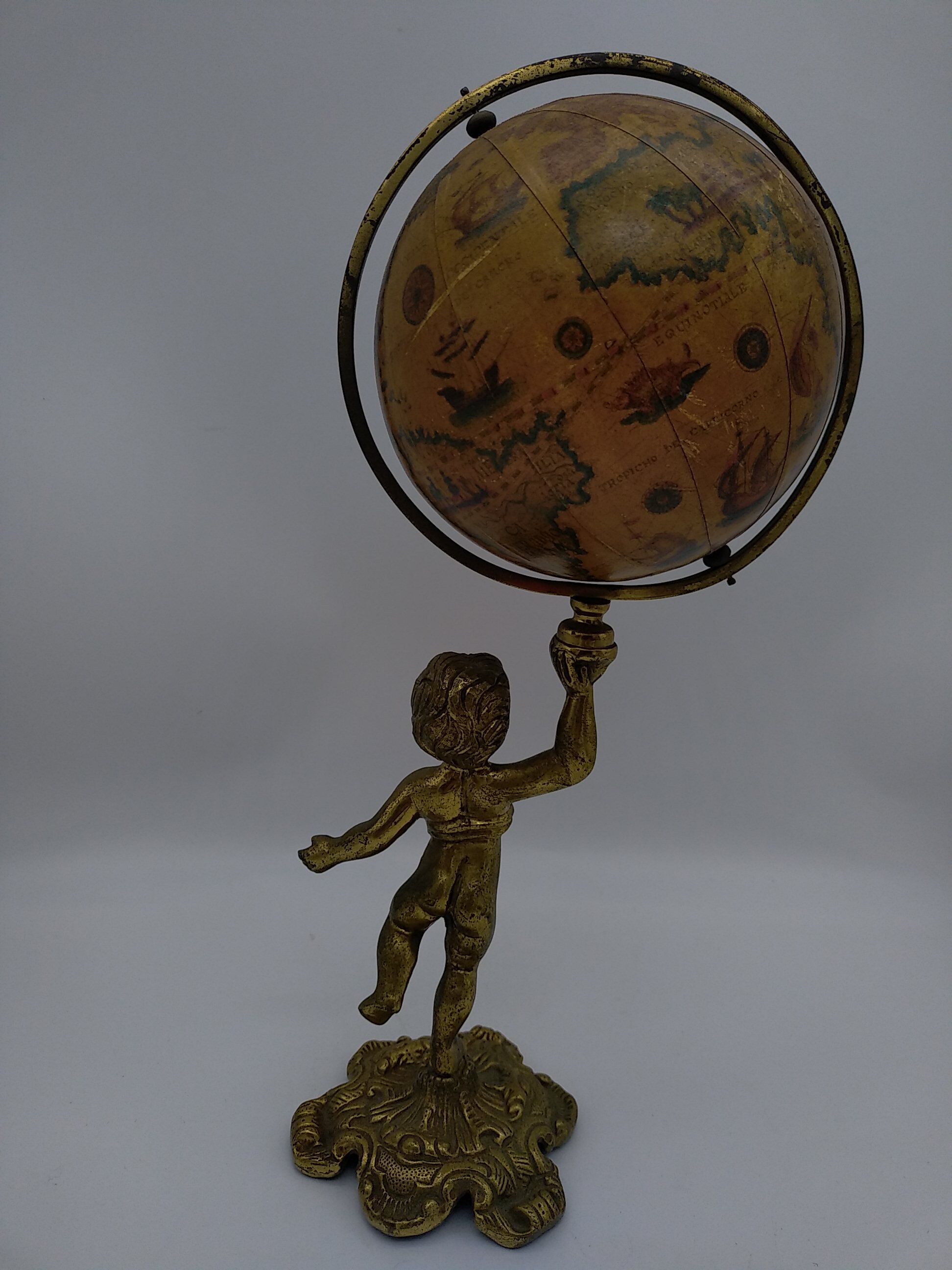 Cherub or putti carrying a globe