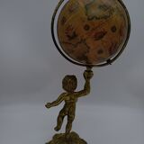 Cherub or putti carrying a globe