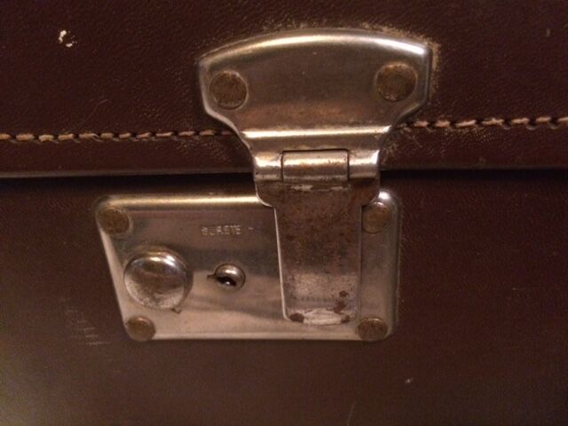 Suitcase vintage leather inside and brown carpeted home