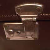 Suitcase vintage leather inside and brown carpeted home