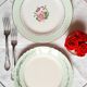 Old mismatched earthenware dinner plates accompanied by a deep dish