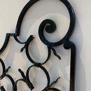 Ancient pair of door opening gates has hell volutes forged craftsmanship