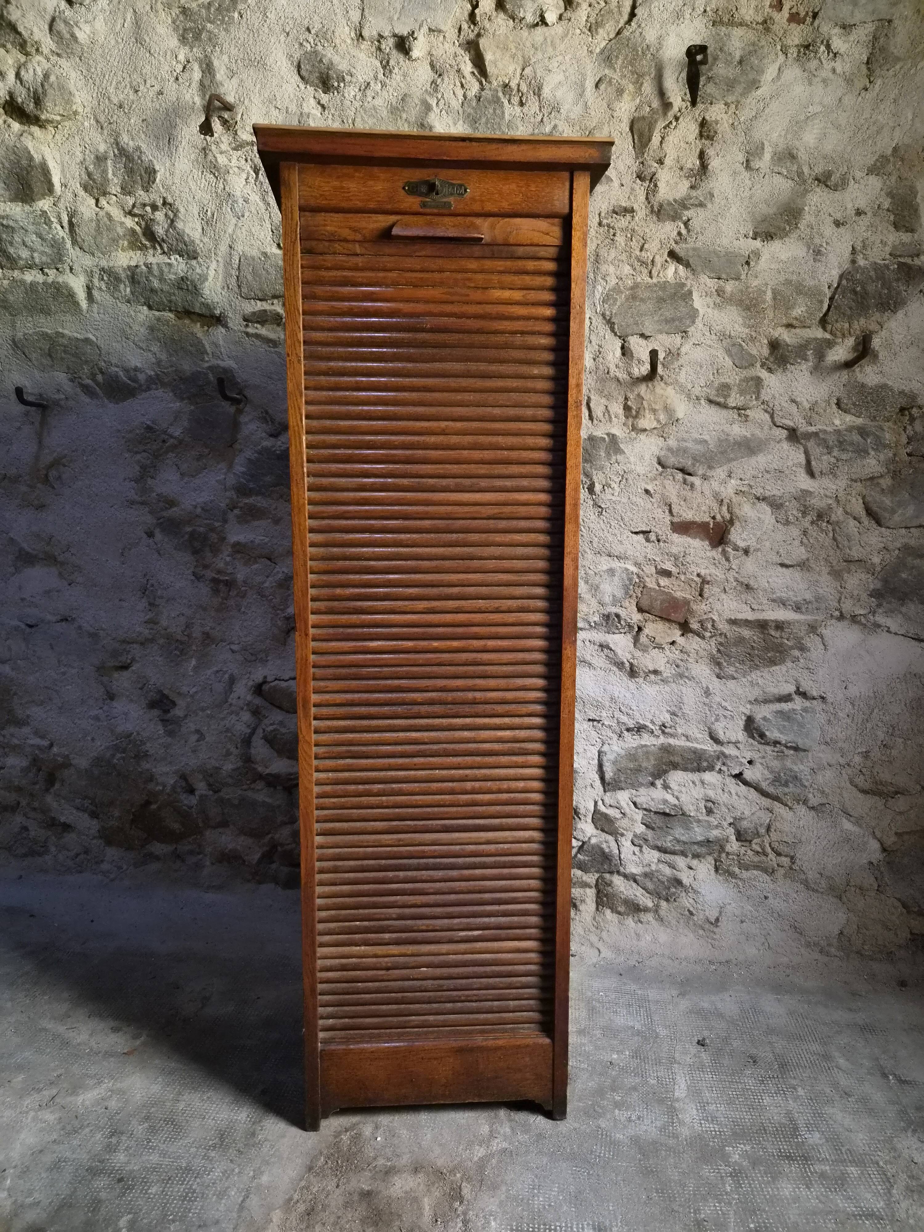 French antique wardrobe with curtain in oak, circa 1920–1930.
