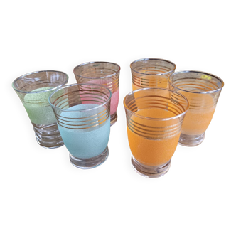 6 granite glasses with gold rim, 4 orange and 2 green. A green glass has a different shape.