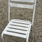 Garden furniture in wrought iron and wooden slats composed of two armchairs, 4 chairs and a table.