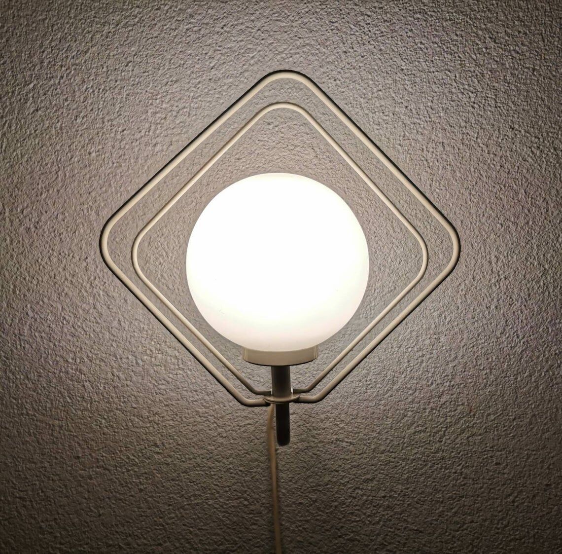 Metal applique with 80s glass sphere