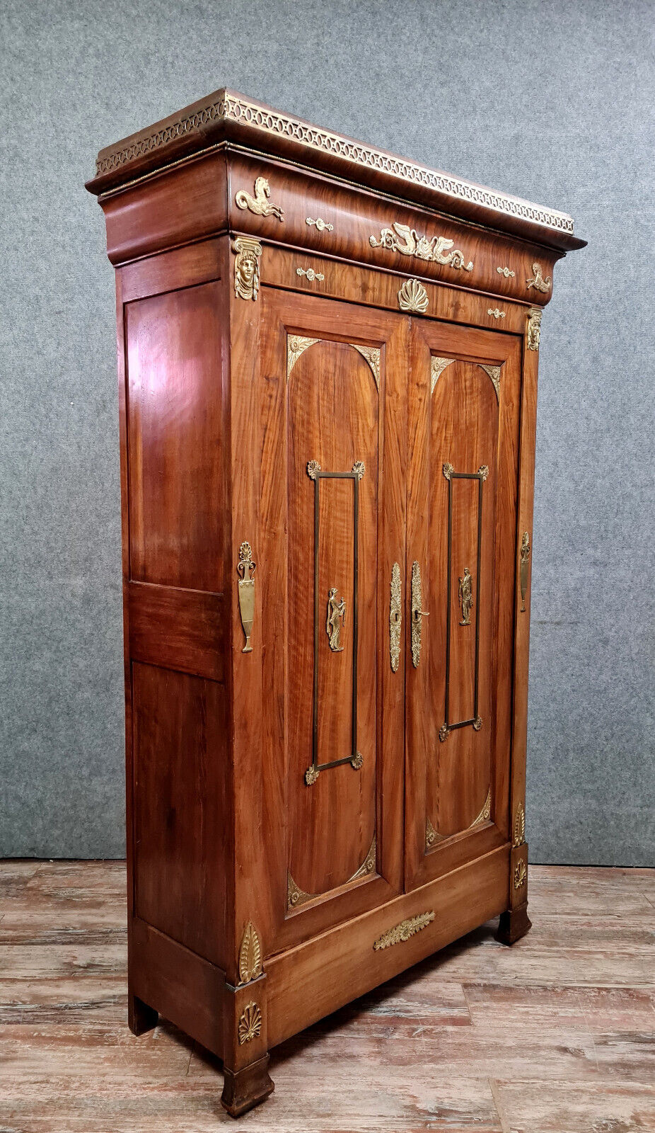 Louis Philippe period wardrobe (nineteenth) entirely covered with gilded bronzes