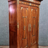 Louis Philippe period wardrobe (nineteenth) entirely covered with gilded bronzes