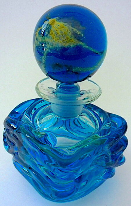 Blown blue glass bottle with inclusions