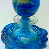 Blown blue glass bottle with inclusions