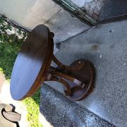 Art Deco side table in brown walnut, round top and scroll legs, France 1930s.