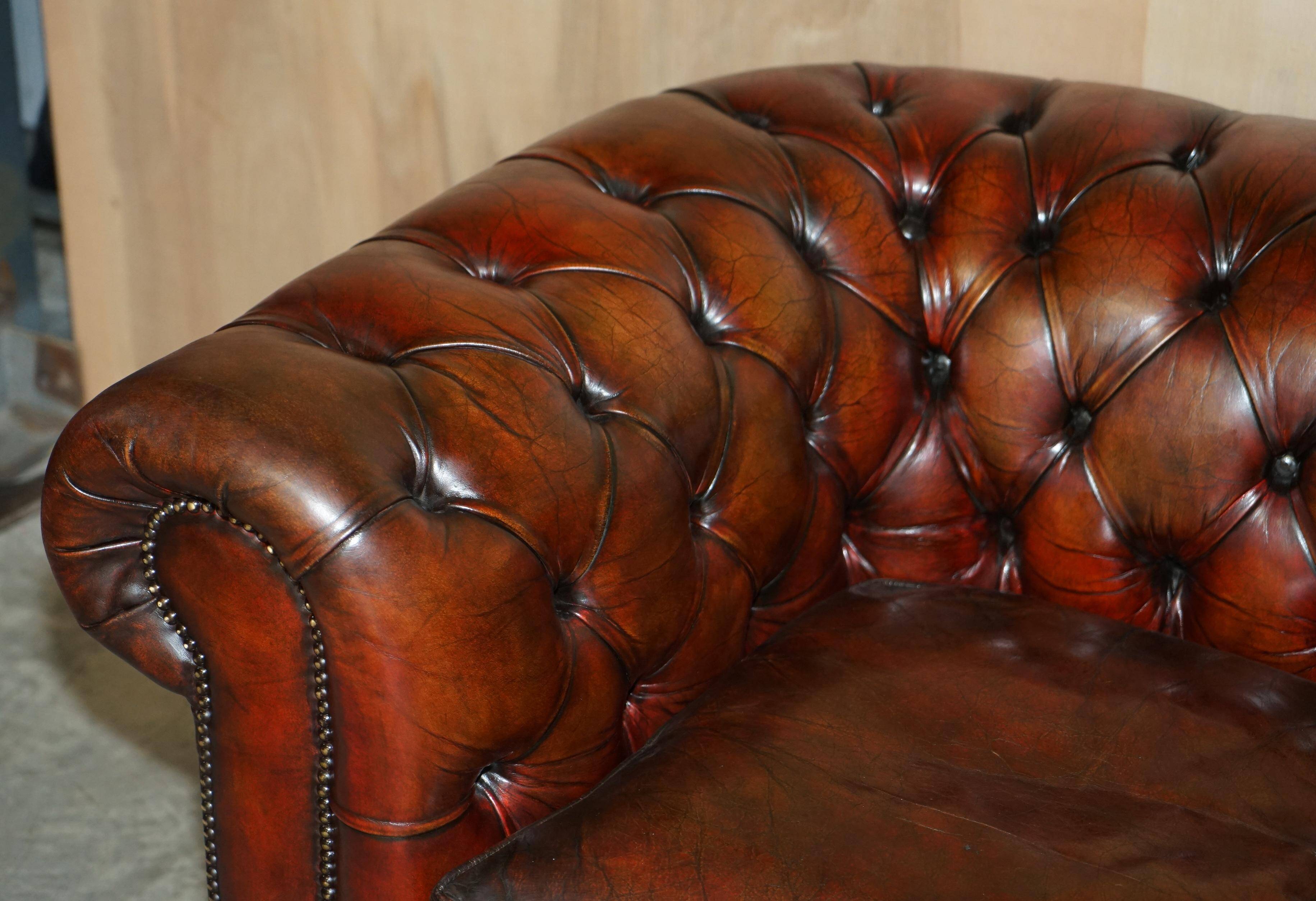Pair of restored antique Chesterfield sofas in Boudreaux leather.