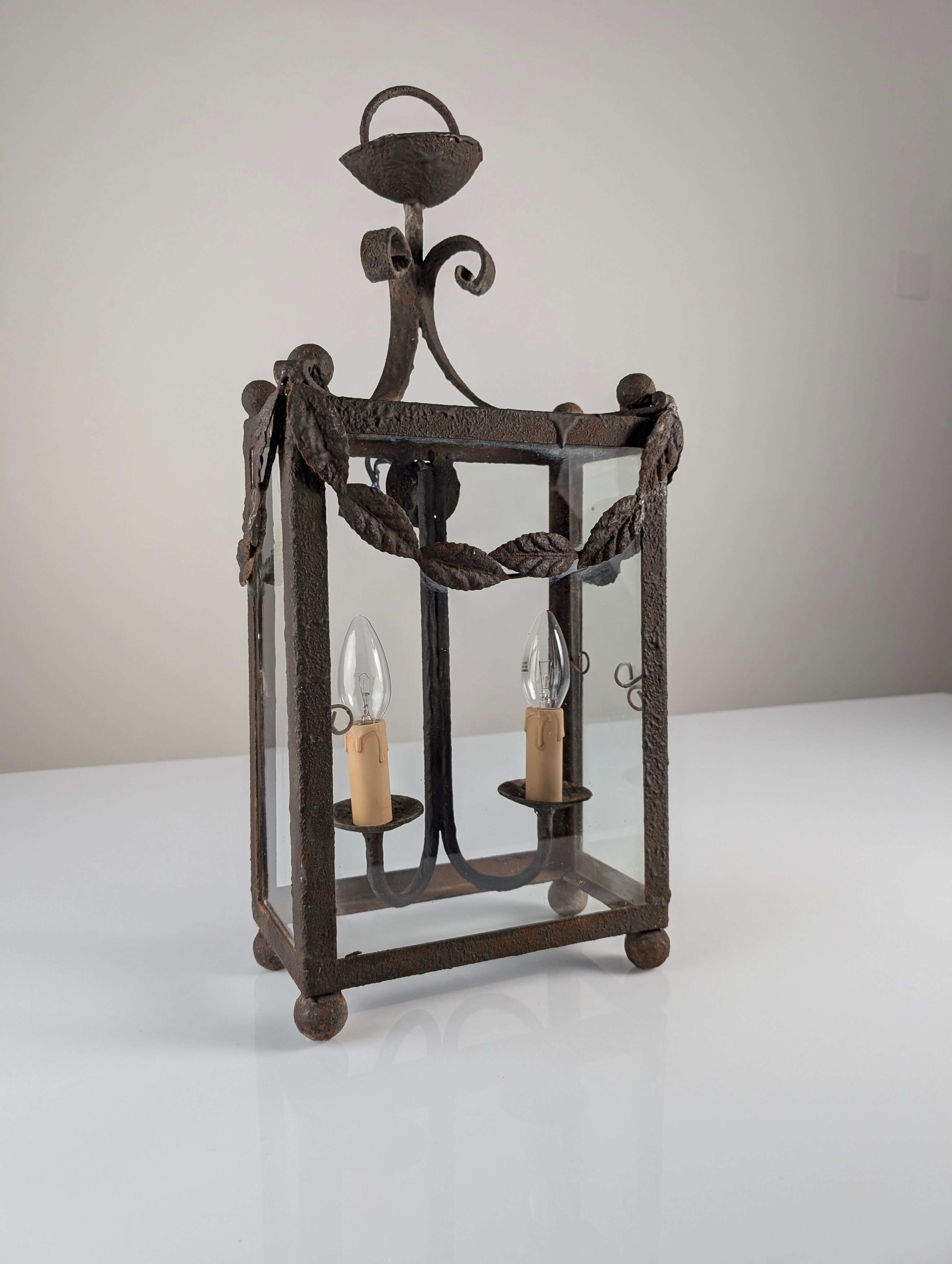 Wrought iron lantern with glass panels, leaf motifs
