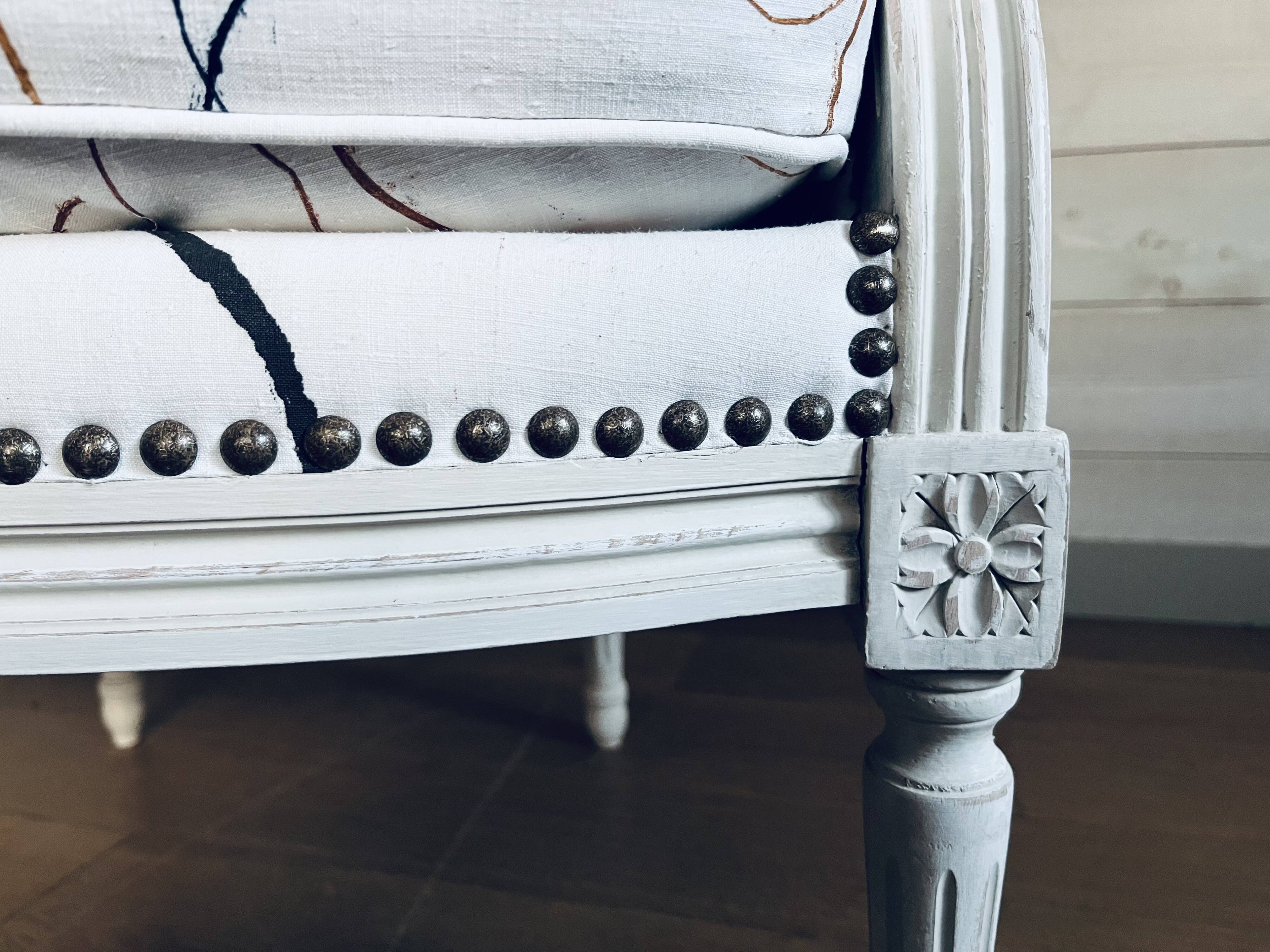 Shepherdess reupholstered with old linens by Sophie de Garam