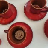 Red enamelled terracotta: cups, saucers, glasses