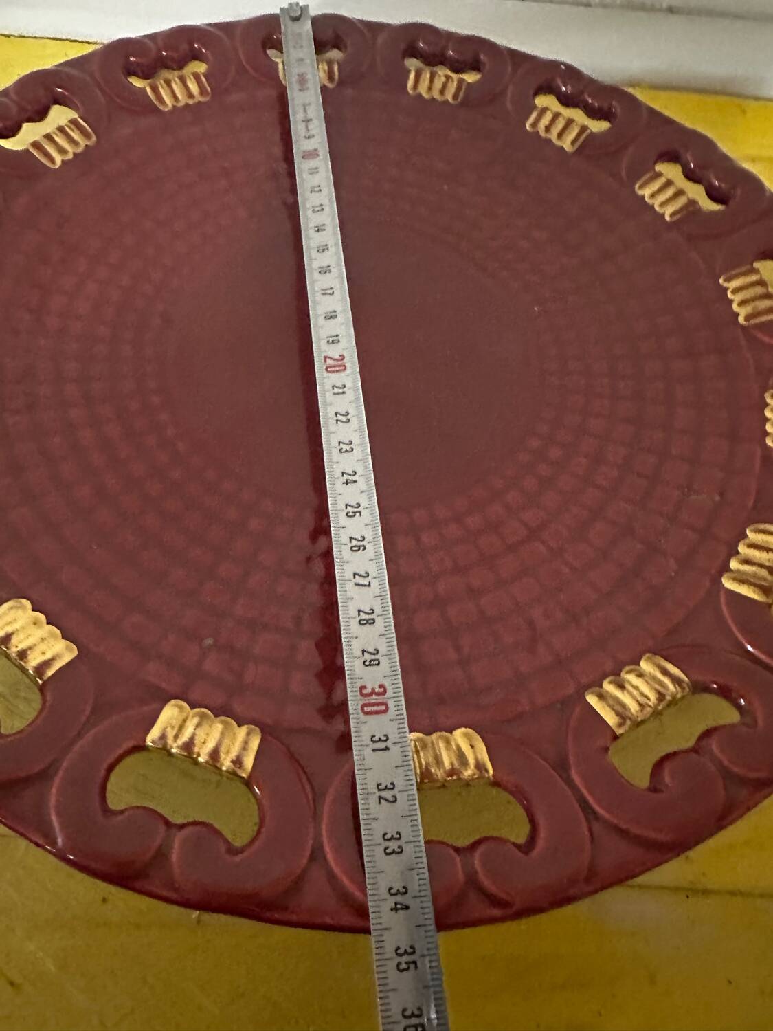 Burgundy and gold openwork plate in ceramic from Saint-Clement, 1950s.