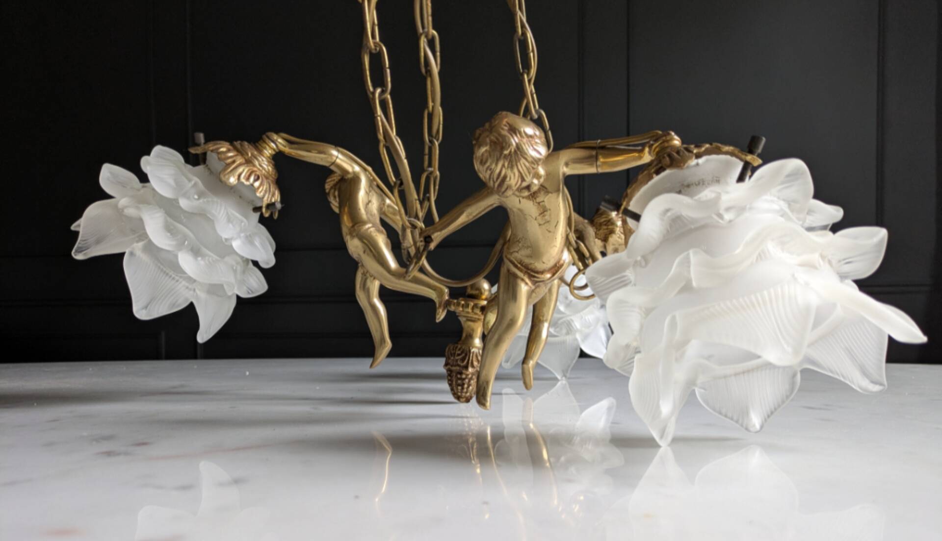 Vintage chandelier with cherubs and frosted glass flowers.