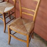 Set of 5 mismatched straw chairs.