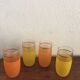 Four glasses in orange granités in orange and yellow