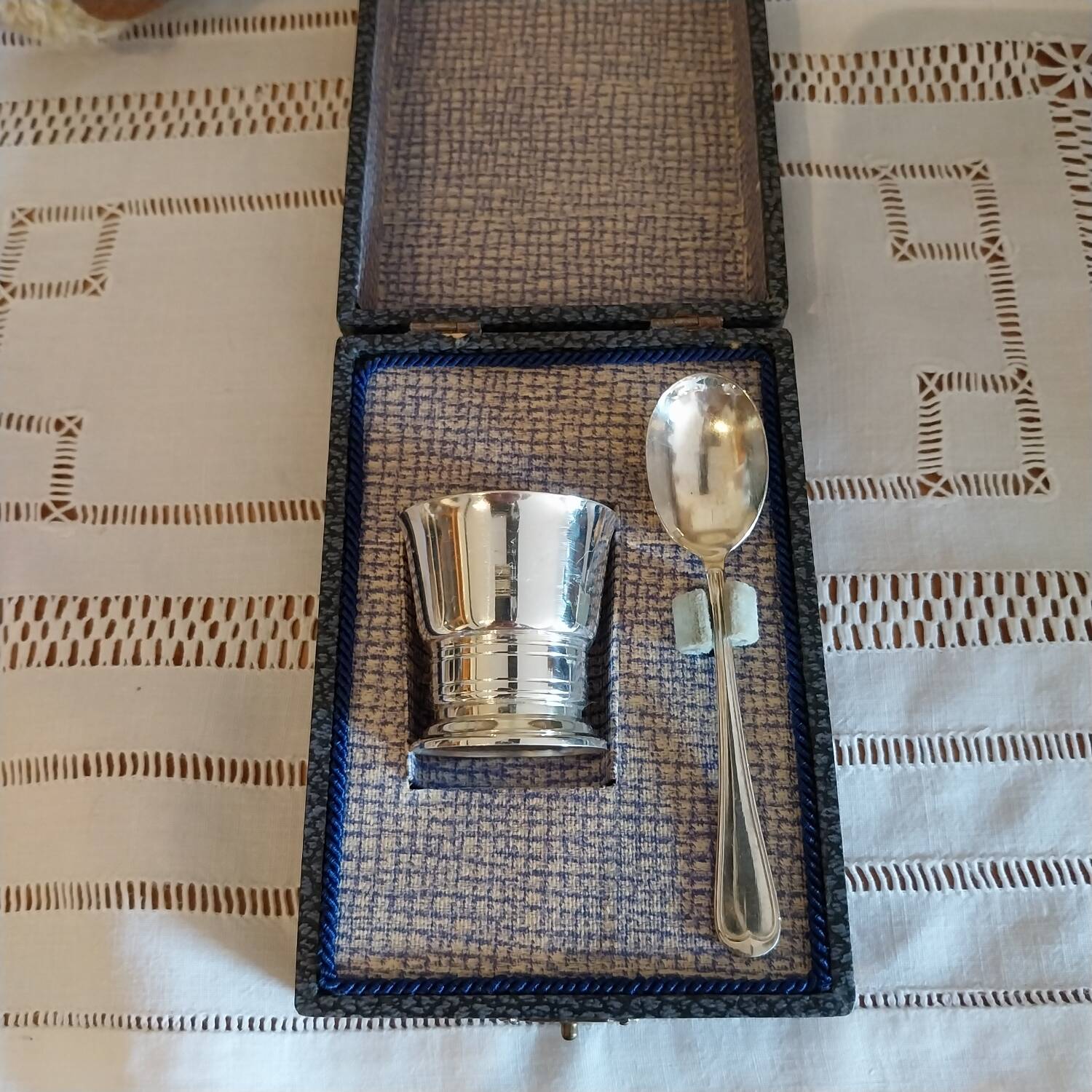 Egg cup and spoon in silver metal