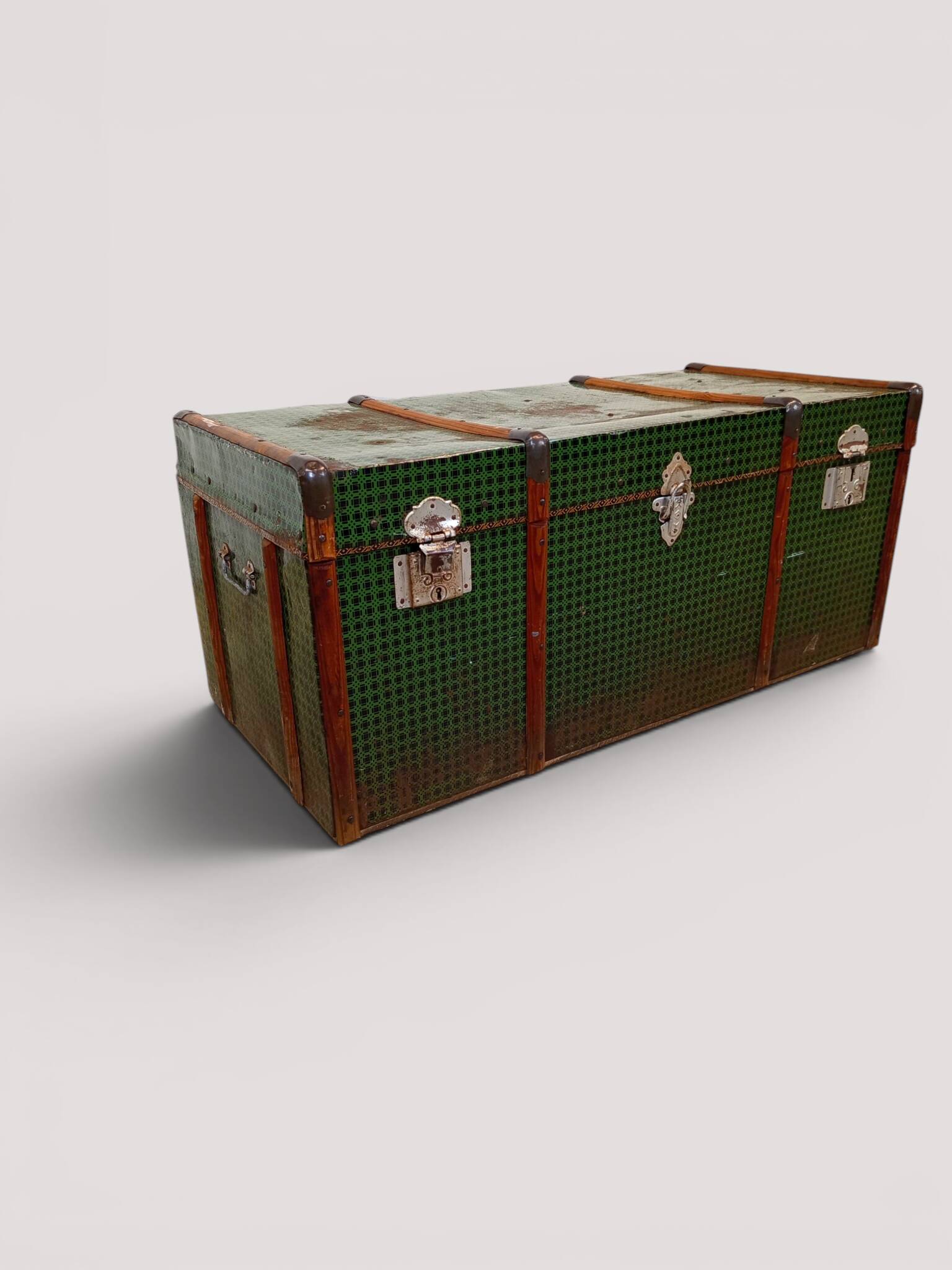 Vintage wooden and metal green travel trunk, circa 1930.