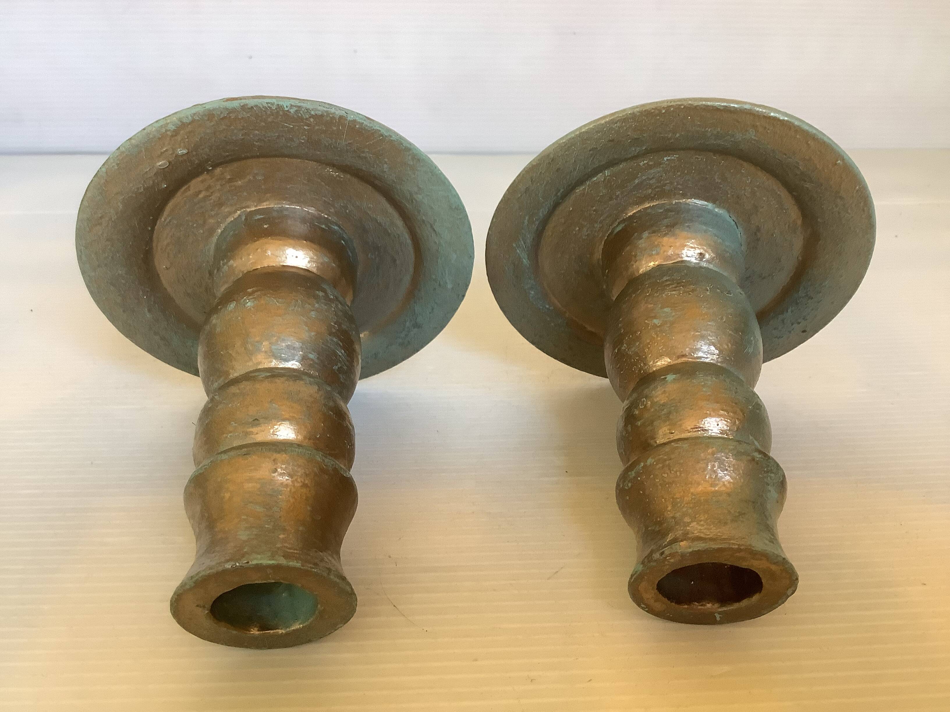 Pair of green and gold wooden candlesticks