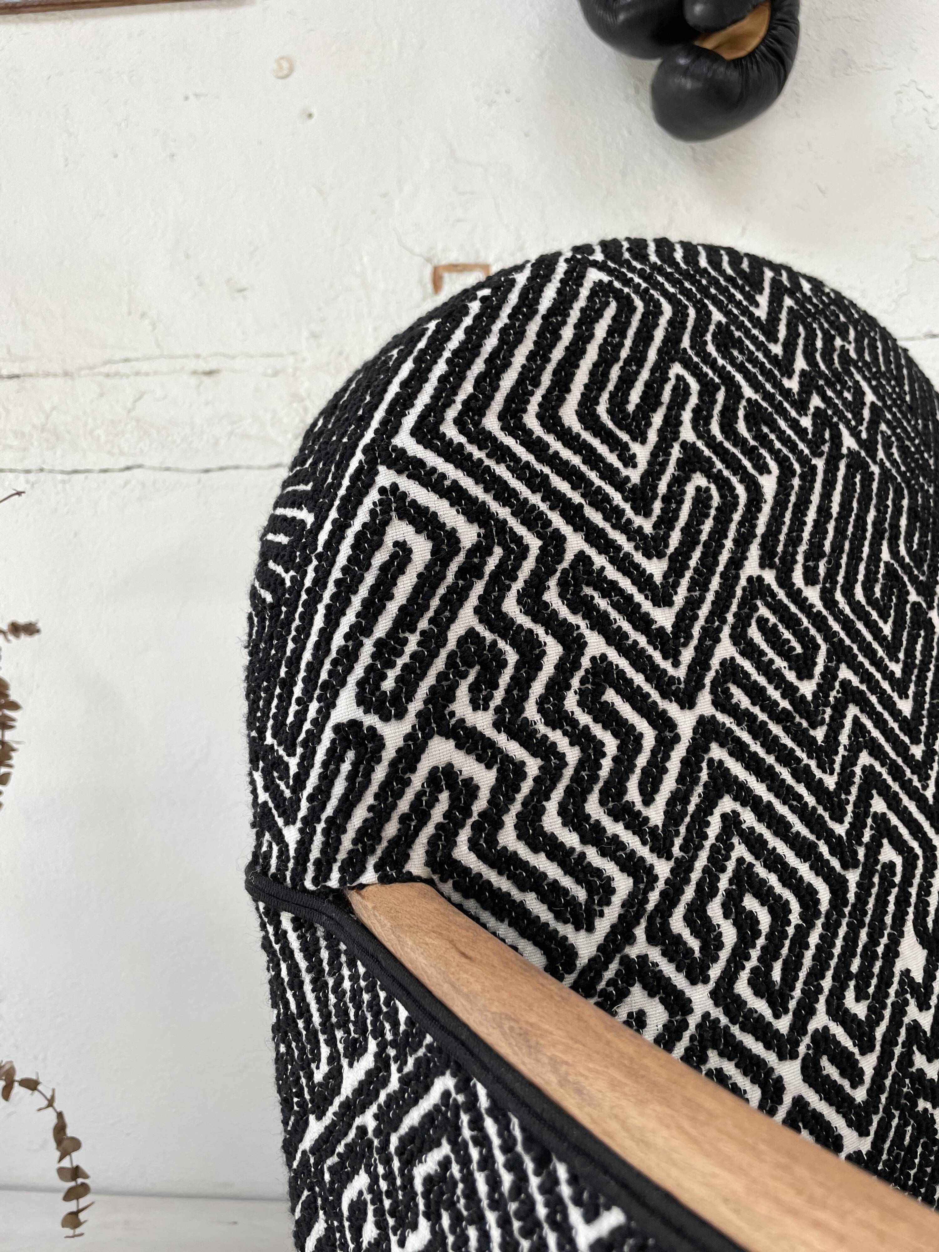 Club armchair in wood and fabric.