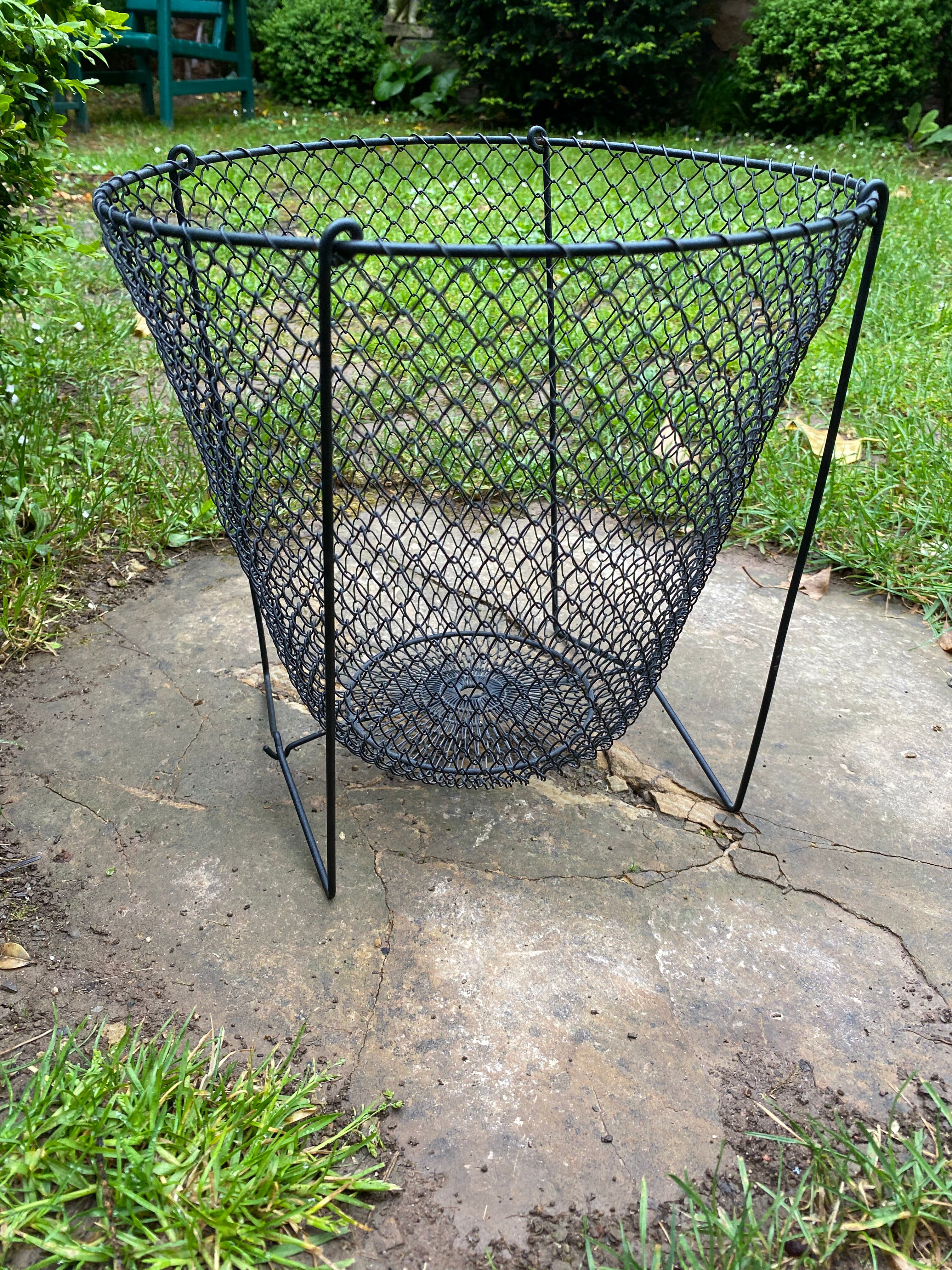 Foldable black woven metal wastepaper basket from around 1950.