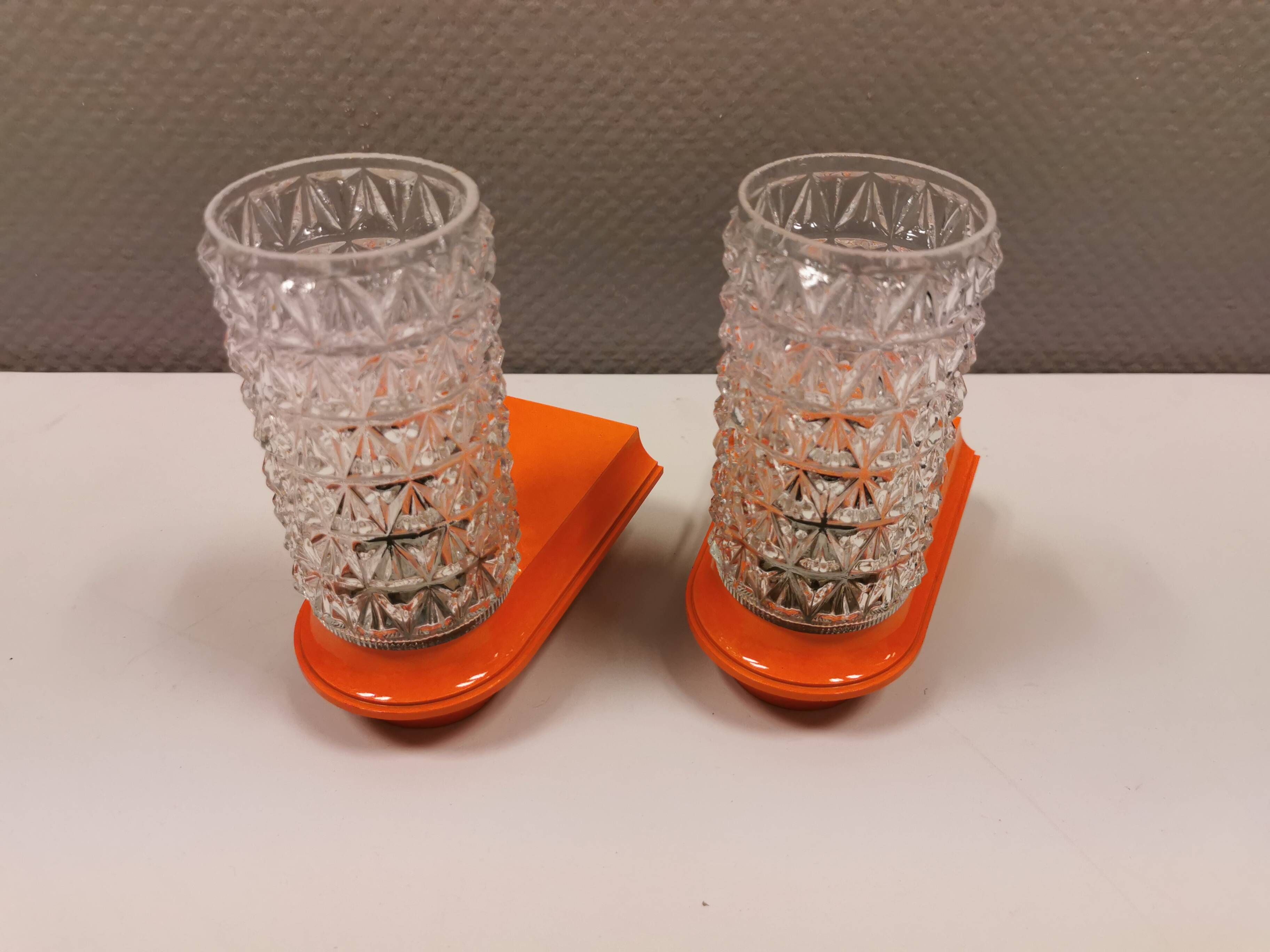 Bathroom lamps in a nice orange colour with a crystal glass shade and a base of hard thin plastic