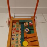 Educational game wood cubes on wheeled cart