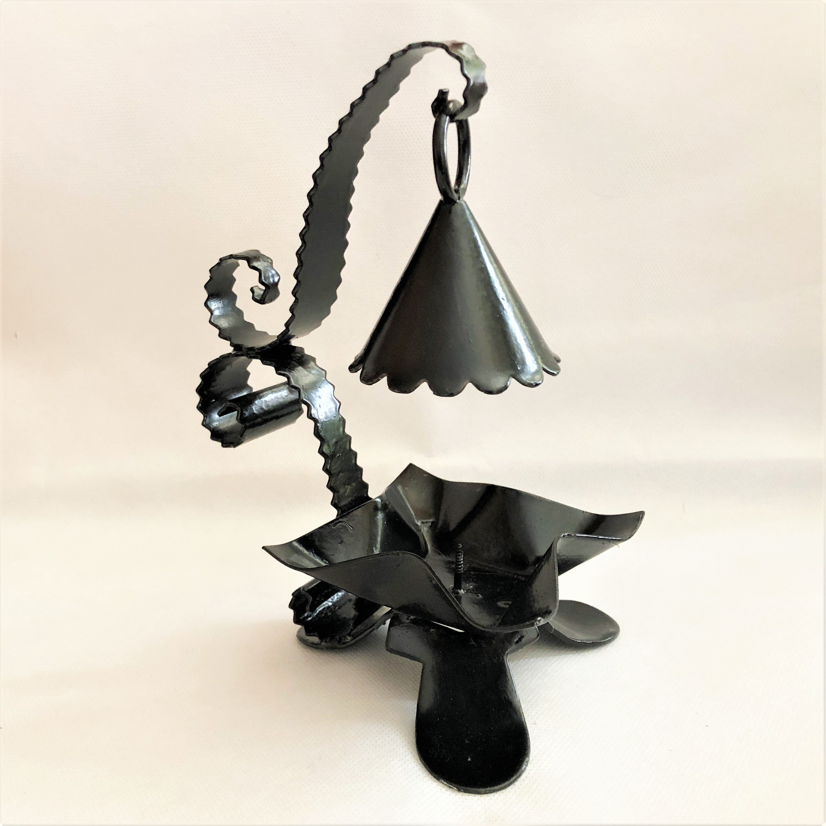 Handcrafted black wrought iron candle holder with its vintage extinguisher