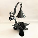 Handcrafted black wrought iron candle holder with its vintage extinguisher