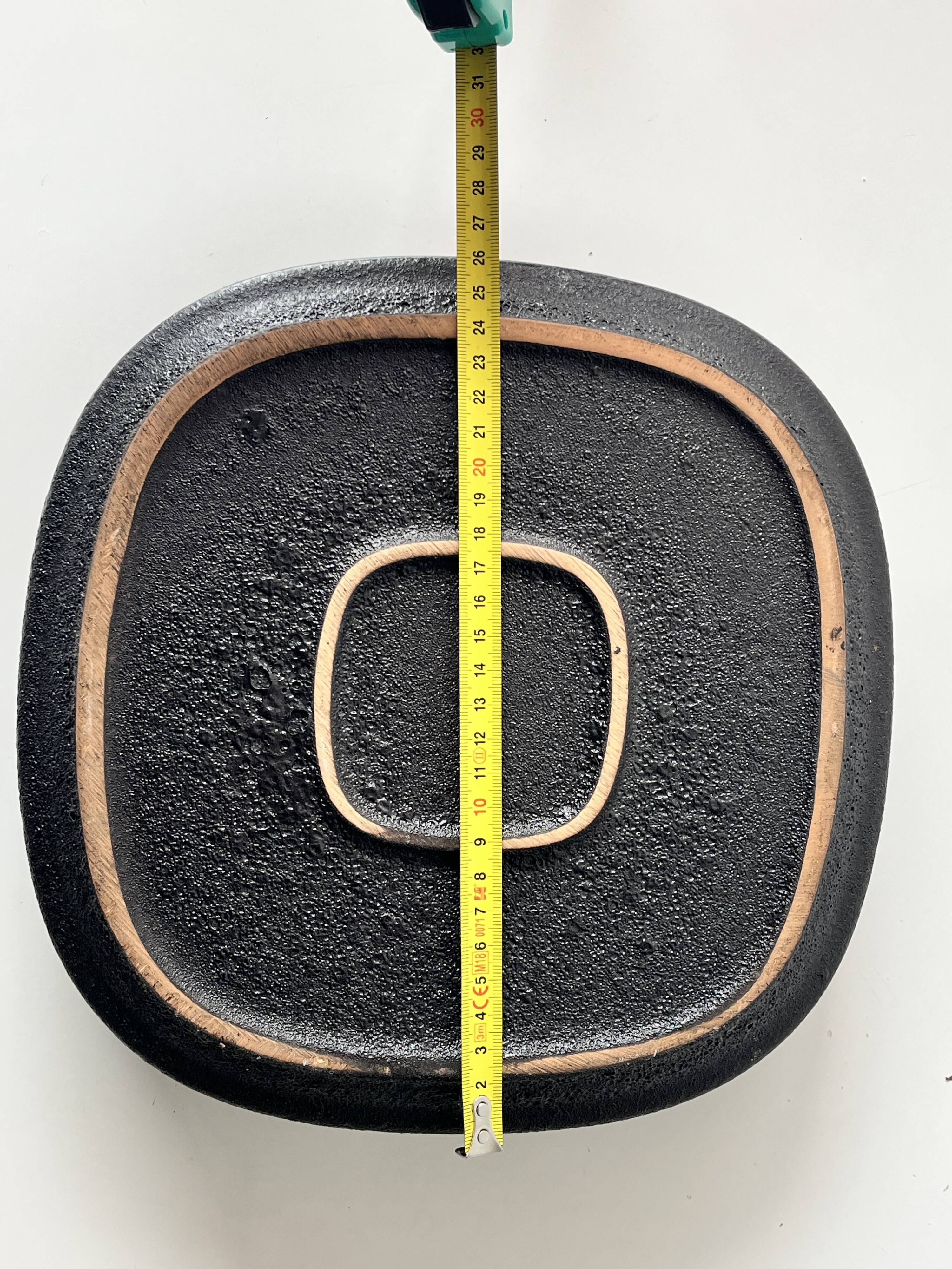 Large decorative ceramic catchall with red and black spiral pattern.