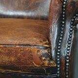 Cognac-colored vintage sheep leather wingback chair with character