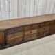 Long low oak countertop with 12 drawers - early XXth