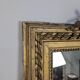 Golden Louis XVI style mirror with bouquet and shells.