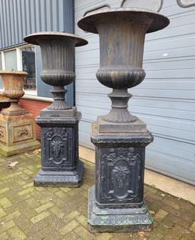 Large antique cast iron vases on pedestal