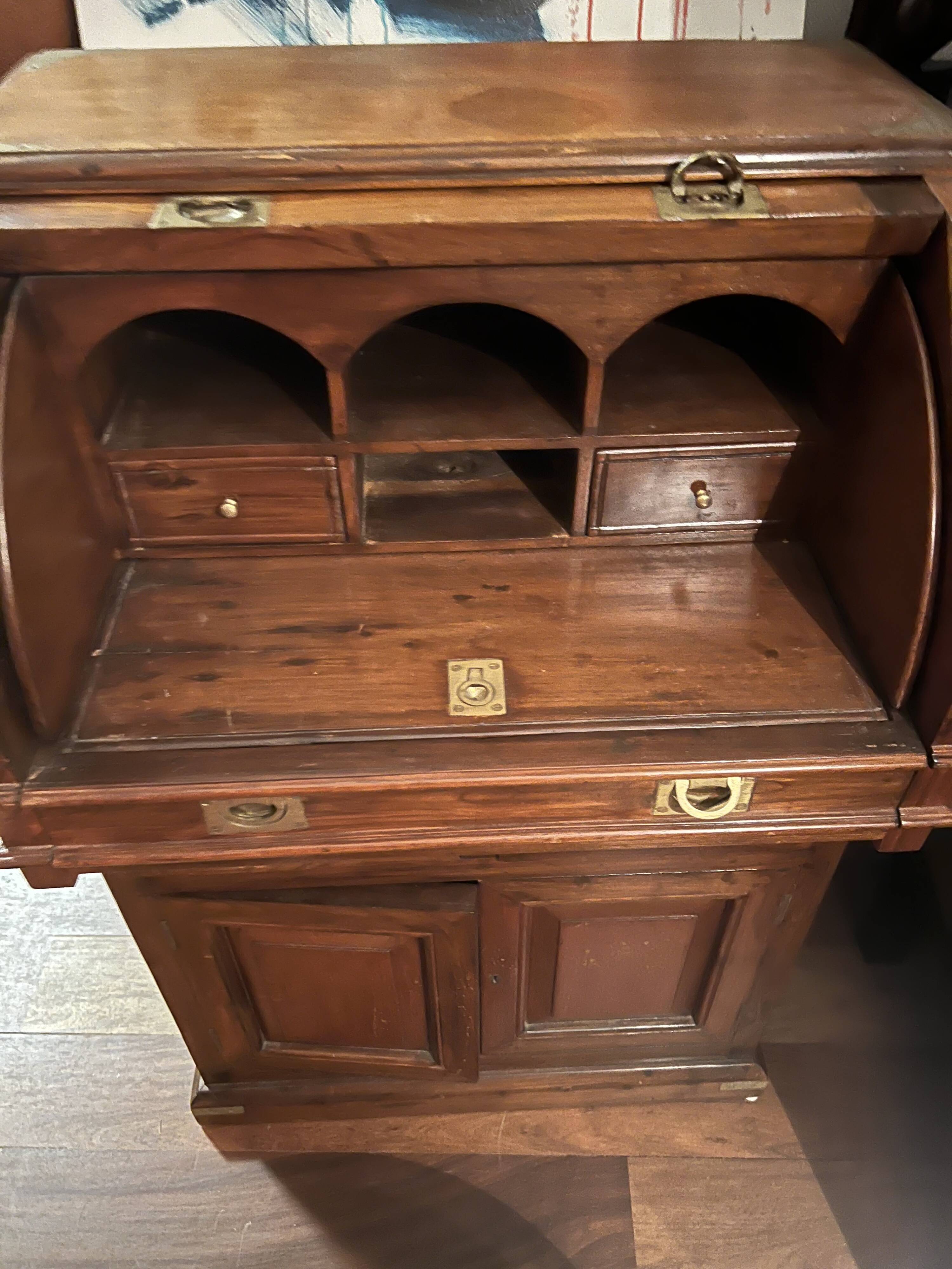 Antique solid wood secretary with a drop-down cylinder compartment.