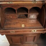 Antique solid wood secretary with a drop-down cylinder compartment.