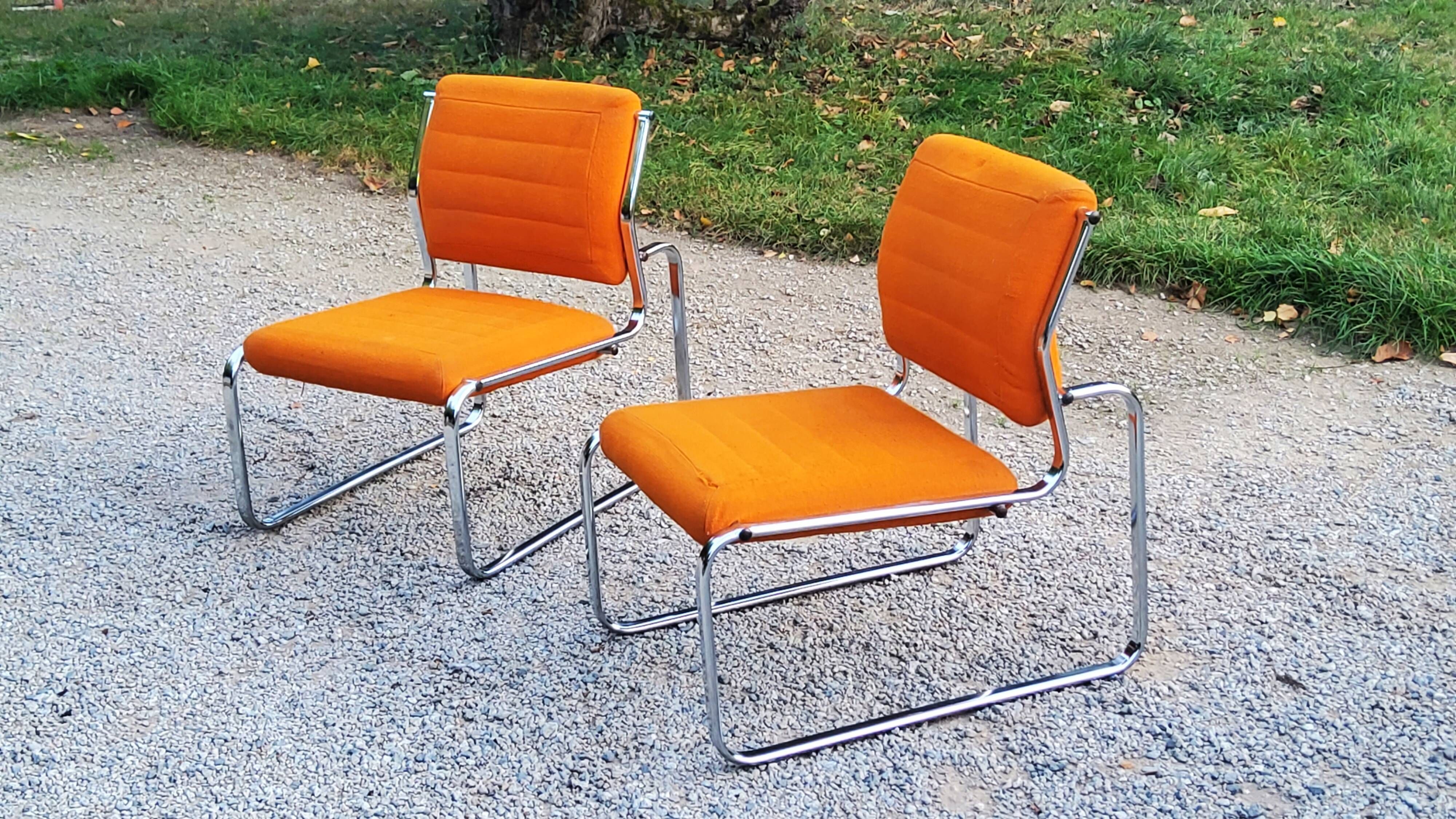 Pair of designer armchairs in orange fabrics and chrome tubes from the 70s